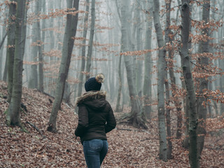 Woman walking at forest. Traveler woman.