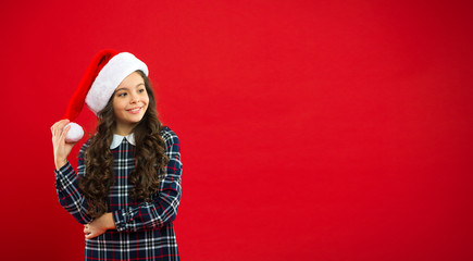 Happy winter holidays. Small girl. Present for Xmas. Childhood. Christmas shopping. Little girl child in santa red hat. New year party. Santa claus kid. Magic moment. copy space.