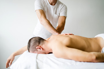Fototapeta na wymiar Young man Having Massage At Spa