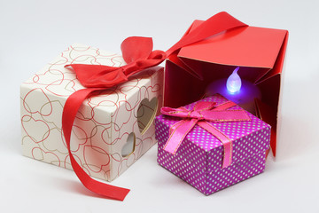 Red, white and purpure gift boxes with hearts and red ribbon with bow,.
