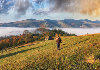 tourist in the mountains. photographer takes a sunrise in the mountains