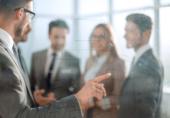 young man drawing flowchart on glass board