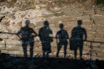 shadows from four people on the wall