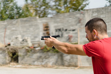 Young man shooting the gun
