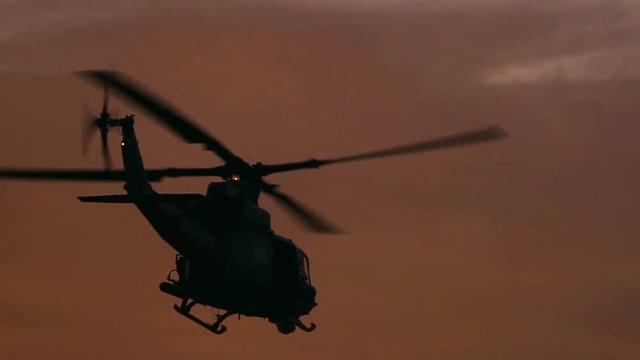 Beautiful shot of a military helicopter taking off at sunset