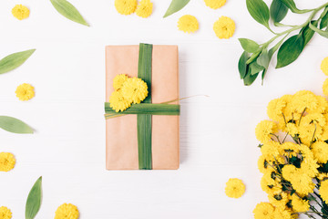 Gift box in brown eco paper on white table