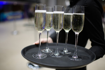 Champagne in the hands of the waiter