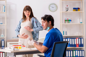 Pregnant woman visiting doctor for check-up