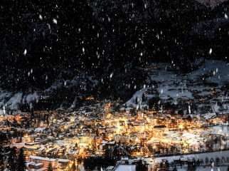 Night view of village in mountains during snowfall in the night