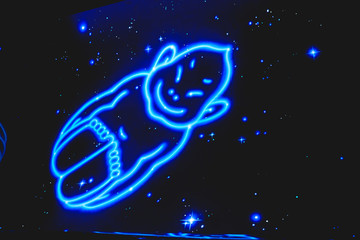 Blue neon art of Billiken, The God of Things As They Ought to Be, Shinsekai, Osaka, Japan