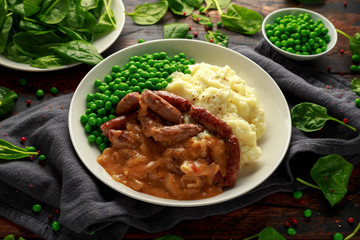 Mashed potatoes and sausages, bangers with onions gravy, green peas