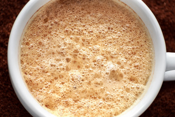 Close up of coffee cup with roasted coffee.