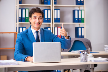 Young handsome businessman working in the office 