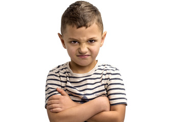 portrait of a little frowning boy on a white background. Emotions