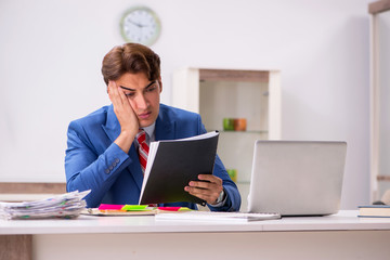 Young attractive businessman working in the office  