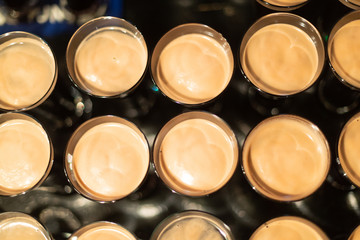Beer glasses with dark beer are on the bar counter