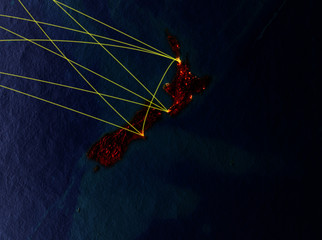 New Zealand from space on model of planet Earth with networks. Detailed planet surface with city lights.