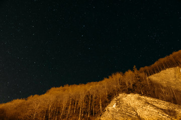 Night picturesque view. The wonderful starry sky s time and the majestic mountain range, with...