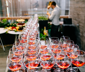 Red cocktail with strawberries. Strawberry daiquiri made with rum,brandy,lime juice, fresh strawberries,grenadine. Refreshing cocktails for a big company. A party. Soft focus.