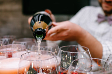 Red cocktail with strawberries. Strawberry daiquiri made with rum,brandy,lime juice, fresh strawberries,grenadine. Refreshing cocktails for a big company. A party. Soft focus.