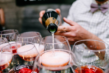 Red cocktail with strawberries. Strawberry daiquiri made with rum,brandy,lime juice, fresh strawberries,grenadine. Refreshing cocktails for a big company. A party. Soft focus.