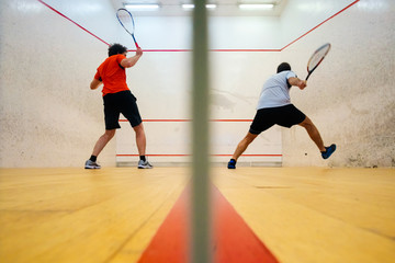 Two friends playing squash in Mutilva, Navarra, Spain