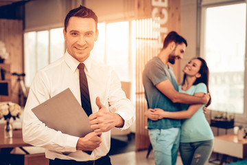 Furniiture Seller With Couple On A Background.