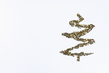 Christmas layout. Golden confetti in the form of stars folded in the shape of Christmas tree on white background. New Year 2019, christmas, winter concept. Copy space, tov view, flat lay composition.