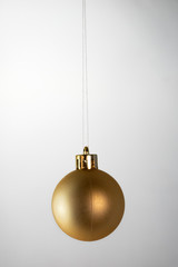 Golden christmas ball on white background