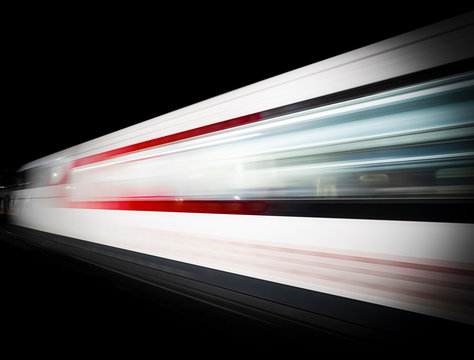 Abstract image of a train departing a European station at night