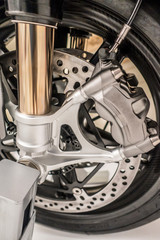Motorcycle wheel with dic brakes and shocks close up