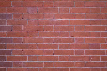 red brick wall with cemented joints