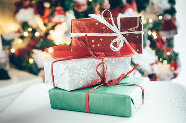 Christmas gifts, in the background a blurred Christmas tree