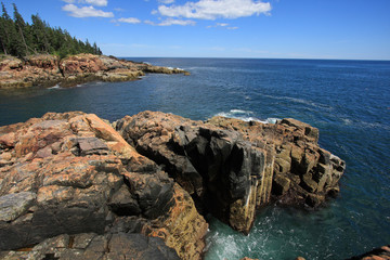 Fototapeta na wymiar The rugged coast of Acadia National Park, Maine, under a clear and sunny summer day.