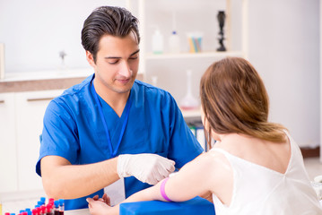 Young patient during blood test sampling procedure  