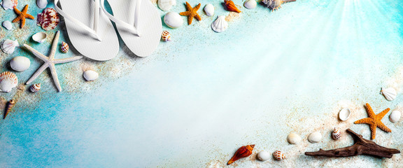 Seashells And Starfish On Blue Background With Flip-flops And Driftwood
