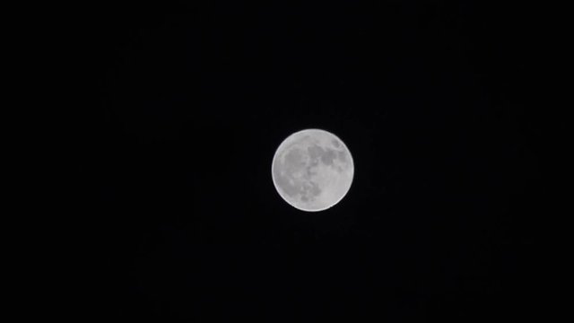 Full moon in the night sky is clear.