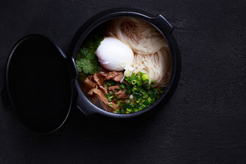 Japanese ramen soup with chicken, egg and chives. hot nourishing food, pan asian cuisine, restaurant menu