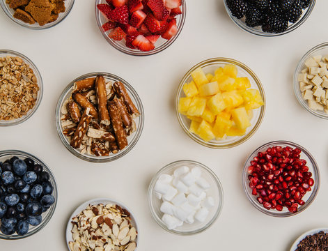 assorted dessert toppings of fruit, nuts and sweets