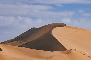 Naklejka na ściany i meble Sand dunes and desert under blue sky at Mingsha Mountain, in Dunhuang, Gansu, China