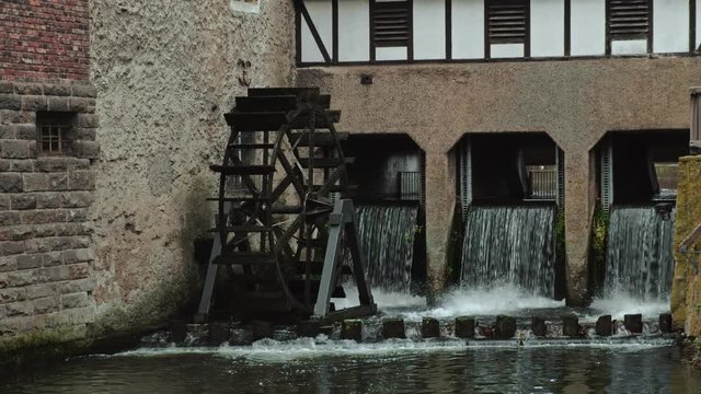 Ultra HD video of wooden watermill driven by falling river stream 
