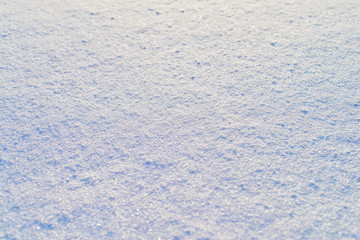 High angle view of snow texture, background with copy space. Snow texture or winter white background with grain rough pattern