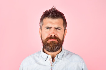 Sad bearded man in casual clothes. Fashion model with stylish hair. Grieved man with long beard and...
