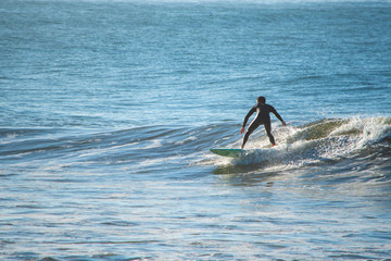 One surfer riding a wave in Southern California.