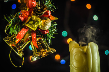 Christmas candles. The smoke from the extinguished fire candles on the background of Christmas tree...