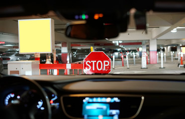 stop sign in front of the car at parking lots