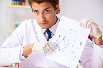 Forensic expert studying fingerprints in the lab