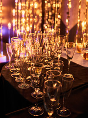 New years eve festive celebration blurry background with glasses of champagne. Vintage gold Fireworks and bokeh in New Year eve and copy space. holiday background