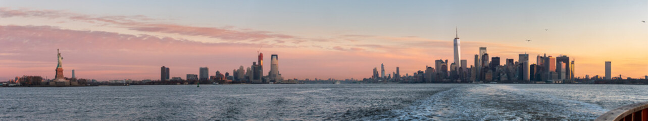 Fototapeta premium View of the Statue of Liberty From the Staten Island Ferry with Downtown Manhattan on the Right