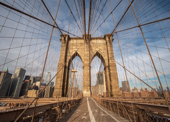 The Upper Deck Walkway of the Brooklyn Bridge Facing the Manhattan Skyline During a Clear Sunny Day